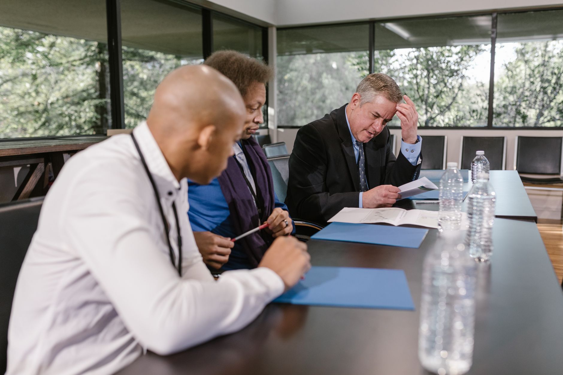 A management team reviewing documents during a business crisis meeting