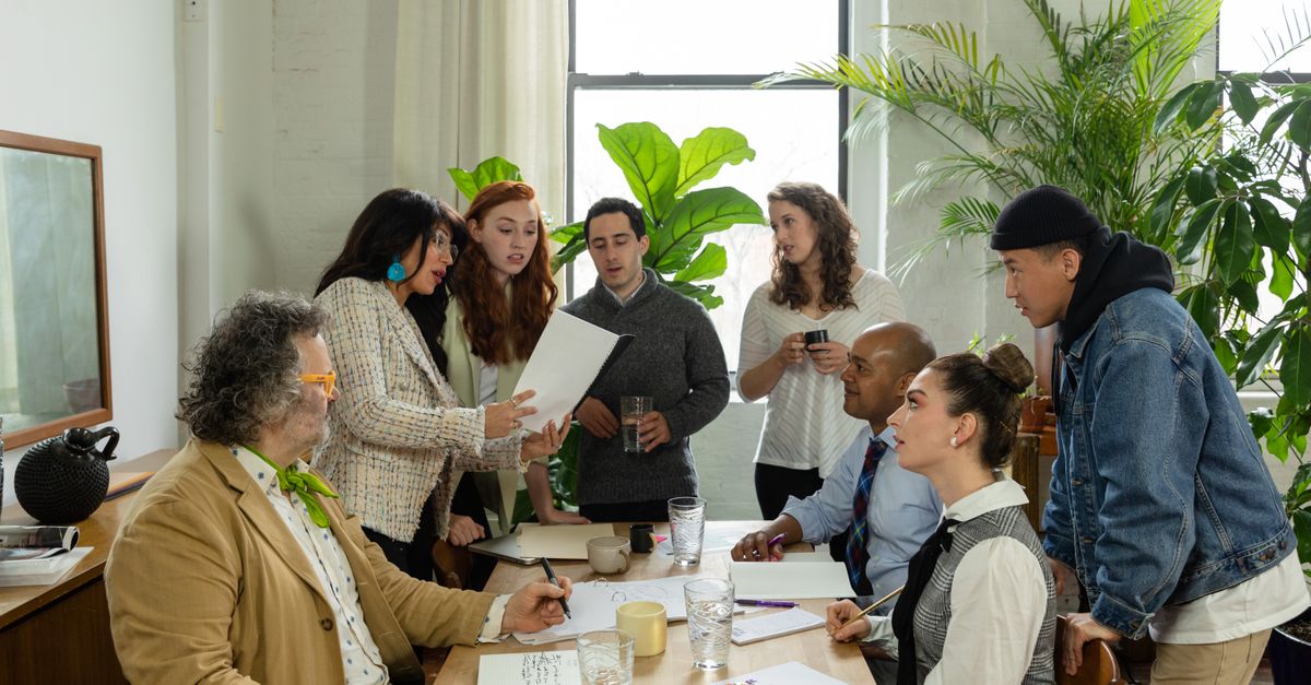 A multicultural team having a productive office meeting surrounded by greenery.