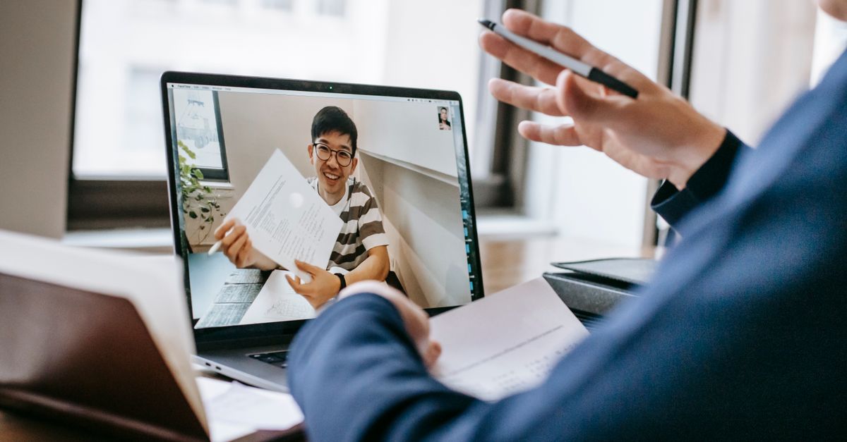 Two professionals engaged in a video conference showing office documents.